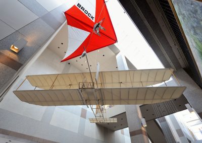 The 1911 Glider fittingly beside the Rogallo Hang Glider in the museum atrium. The 1911 Glider soaring record lead to the aviation sport of soaring including hang gliding, sail planes, ultralights, and paragliding.